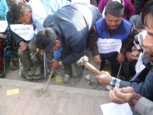 CITY FOR ALL: A group of disable people demanding pavements adapted for them try to remove bricks from the sidewalk, at Ratna Park, Thursday afternoon.