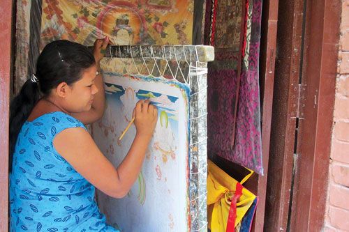 HIGH SKILLS: A young student learns the art of Thanka making at an institute in Thamel.