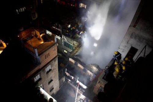 UNDER CONTROL: Fire fighters put out a fire on a building at Bhotahiti, old Kathmandu, on Thursday night. Police reported the fire broke out due to cooking gas leakage.