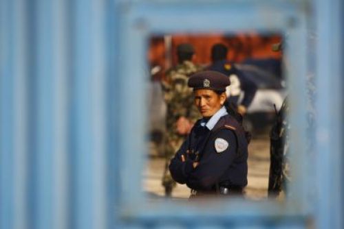 LEAST INTERESTED: A policewoman stationed at Tribhuvan International Airport looks on as President Ram Baran Yadav and his entourage get ready to leave for Delhi on Monday afternoon.