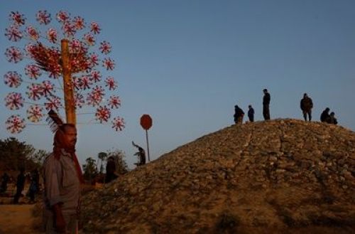 GONE WITH THE WIND: A hawker walks the streets of Chitwan displaying windmills for sale, Tuesday afternoon.