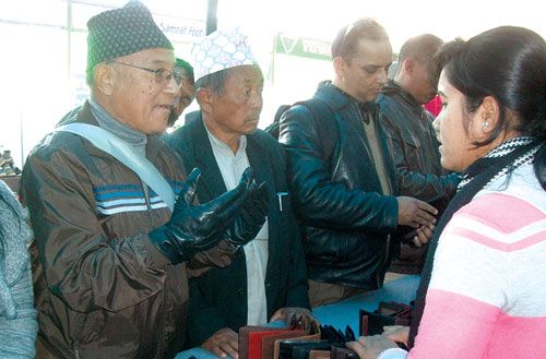 HARD SKIN: A man bargains the price of a pair of gloves at the Leather Fair at City Hall, on Monday. The fair ends on Monday.