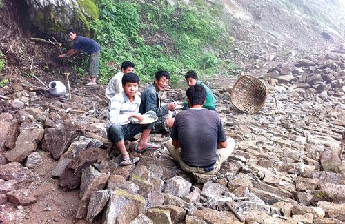 TIME OFF: Labourers working on the road that will connect Bhojpur and Dingla take a lunch break.