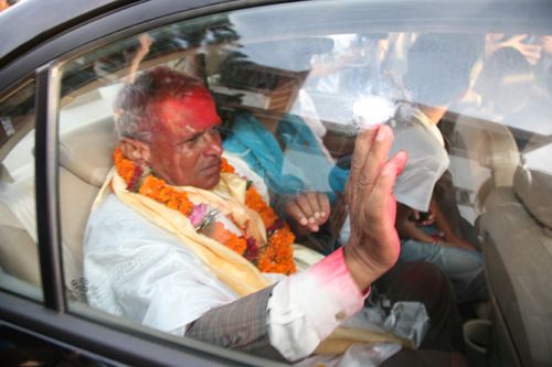 MOBBED: President Yadav being mobbed by supporters outside the constituent Assembly building before driving off.
