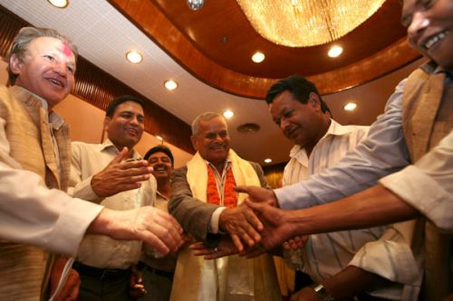 MOBBED: President Yadav being mobbed by supporters outside the constituent Assembly building before driving off.