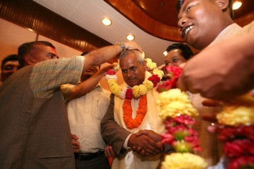 MOBBED: President Yadav being mobbed by supporters outside the constituent Assembly building before driving off.