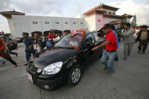 MOBBED: President Yadav being mobbed by supporters outside the constituent Assembly building before driving off.