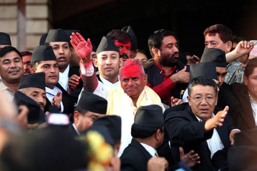 MOBBED: President Yadav being mobbed by supporters outside the constituent Assembly building before driving off.