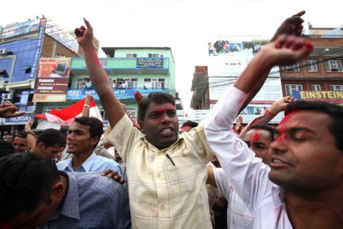 MOBBED: President Yadav being mobbed by supporters outside the constituent Assembly building before driving off.