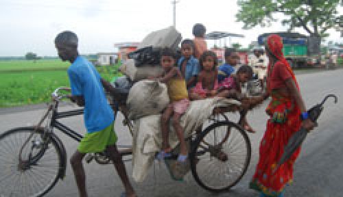 RICKSHAW RIDE: A family flees from the flood to a safer place, packing their lives into small bundles.