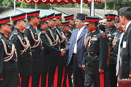 FIRM GRIP: Prime Minister Pushpa Kamal Dahal shakes hands with senior army officers at Tribhuban International Airport before departing for Beijing last Saturday.