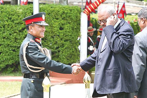 WRONG NUMBER: Minister for Physical Planning Bijay Kumar Gachhadar is distracted by a phone call while greeting Army Commander-in-Chief Rukmangat Katuwal at the airport on Saturday.