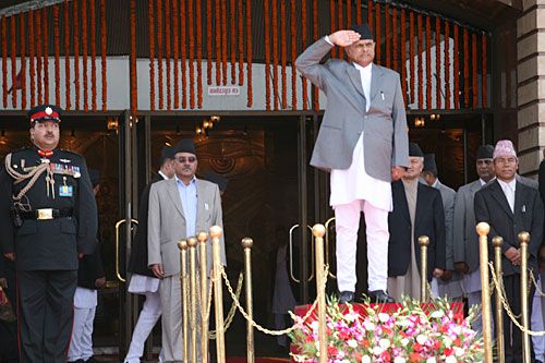 PRESENT ARMS: President Ram Baran Yadav takes the salute after arriving at the Constituent Assembly to deliver the government's policies and programs on Wednesday. Prime Minister Dahal in the background.