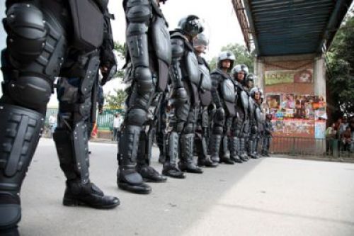 NINJA TURTLES: Riot police in brand new armour guard the street at Jamal on Monday morning as multiple protests caused massive traffic jams.