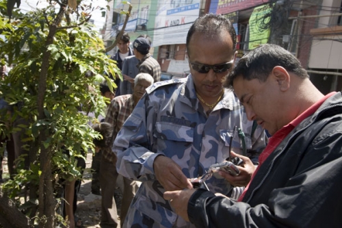 SECURITY RISK: Police examine a socket bomb which exploded at a RPP rally in Baneswor on Monday. One person was injured.