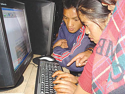 SURFING IN ROLPA: Young women in Thawang learn to use a new computer installed at their local library recently set up by students of Kathmandu University and Tribhuban University as part of a joint effort to take educational materials to remote areas of Nepal.