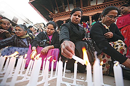FLAMES OF SOLIDARITY: Women CA members light candles in Basantapur on Wednesday to call for an end to violence against women.