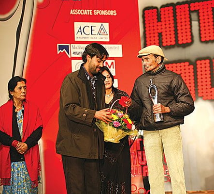HONOURING THE MASTER: Veteran singer Bhakta Raj Acharya, seen here with his son singer Satya Raj Acharya, receives the Lifetime Achievement Award during the 12th Hits FM Music Awards at the Army Club on Saturday.