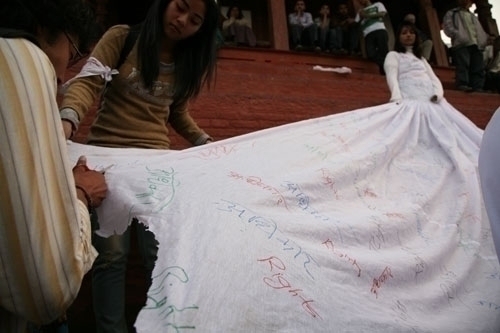 NO MORE TYRANNY: Performance art at Hanuman Dhoka on Sunday evening. Ashmina Ranjit (top right) wearing a white shroud represents autocratic rule. The shroud was gradually cut away by the public, representing the end of autocracy in Nepal.