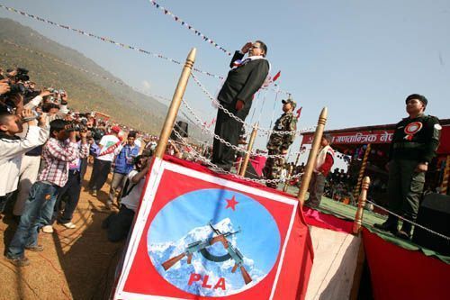 ONE COUNTRY TWO ARMIES: Prime Minister Pushpa Kamal Dahal taking the salute at the 13th anniversary ceremony of the revolution on Thuresday at the Hatikhor camp in Nawalparasi.