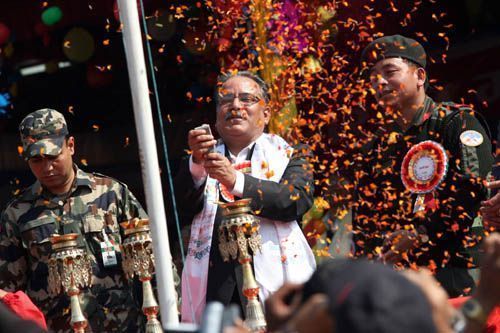ONE COUNTRY TWO ARMIES: Prime Minister Pushpa Kamal Dahal taking the salute at the 14th anniversary ceremony of the revolution on Thursday at the Hatikhor camp in Nawalparasi. He his flanked by a Nepal army bodyguard and PLA commander Nanda Kishor Pun.