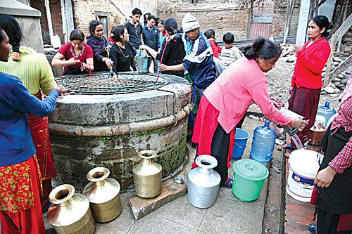 NOT A DROP TO DRINK: Locals crowd around a well that opens only once a day in Purnachandi Tole, Patan. Dry winters have created crippling water shortages in the Valley.