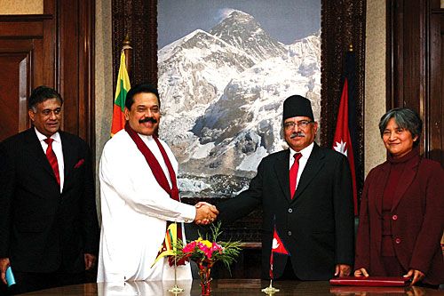 SUMMIT: Heads of state of Sri Lanka and Nepal shake hands after their ministers signed an air services agreement linking Colombo to Kathmandu on Tuesday. Sri Lankan Foreign Minister and Nepal's Tourism Minister Hisila Yami.