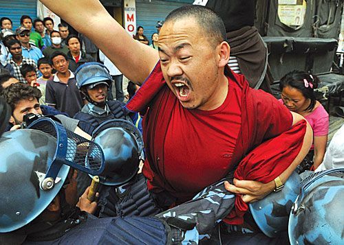 FREE TIBET: Police attempt to arrest a Buddhist monk at a pro-Tibet demonstration at Boudhanath on Tuesday, marking the 50th anniversary of the Tibet Uprising.