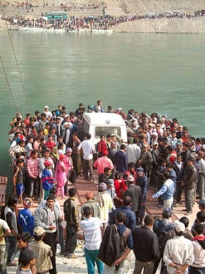 HAPPY NEW YEAR: Passengers throng one of the two ferries across the Kosi as the blockade by Kosi flood victims downstream closed the East-West Highway for more than a week, cutting off eastern Nepal from the rest of the country.
