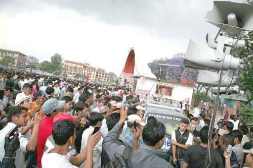 ON THE MOVE: Astonished Maoist cadres capture the PM's resignation speech on mobile phones at Khula Manch on Monday.