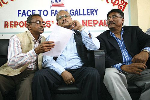 MISTY POLITICS: Madhesi Janadhikar Forum leaders Jitendra Sapkota and Sharat Singh Bhandari help their colleague Bijay Gachhedar decipher a document at an interaction program after he forgot his reading glasses.