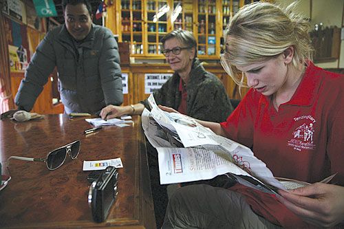 CATCHING UP WITH TIMES: Granddaughter of Sir Edmund Hillary, Emily Rose Hillary, reading Nepali Times in Namche after the Tenzing-Hillary Everest Marathon last week. German Ambassador Verena Grafin von Roedern looks on.