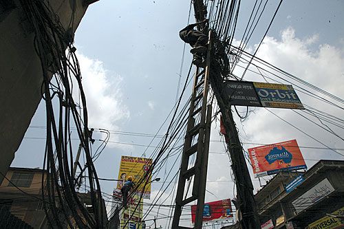 TANGLED: Pultalisadak gets a facelift as workers try to separate the phone lines from tv, internet, and electricity cables on Wednesday.