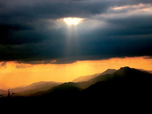 CLOUDS, BUT NO RAIN: The evening sun breaks through clouds in the mountains of central Nepal as a parched land waits for rain. Meteorologists say the monsoons arrived in eastern Nepal this week, but precipitation throughout Nepal has been 50 per cent below normal.