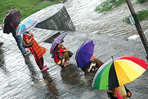 SPLASH OF COLOUR: Kathmandu locals can finally fan out their umbrellas as they enjoy early monsoon showers after a long dry spell.
