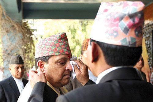 WELL GROOMED: An aide wipes off a tika from the face of ex-king Gyanendra at his 63rd birthday celebration on Tuesday.