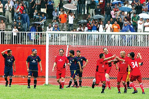 GOOAAL: CA members celebrate NC leader Gagan Thapa's goal at the charity match between political party leaders and artists in Dasharath Stadium on Saturday.
