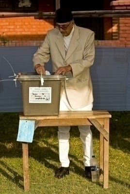 PREMIER VOTE: Prime Minister Girija Prasad Koirala casts his vote in Ward 9's election area 7, Morang District, Biratnagar.