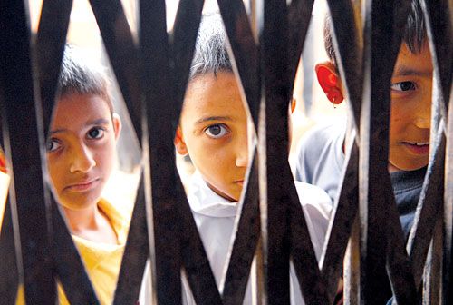 OPEN SESAME: Children wait for a film show in Sandhikharka recently.