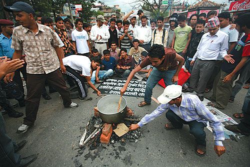 WHAT'S COOKING: NC students protest inflation on the streets by pretending to cook food in front of Bhrikuti Mandap on Friday.