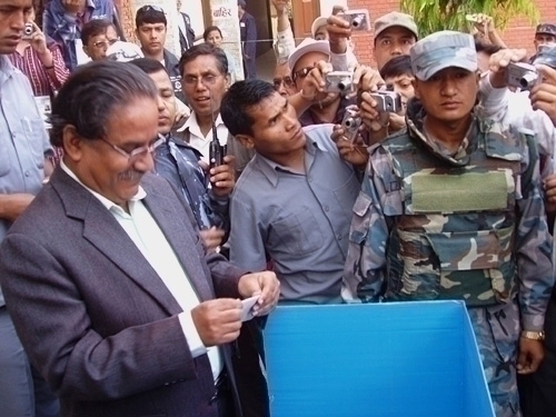 NOT SECRECY: Maoist chairman Pushpa Kamal Dahal voting in Bharatpur 10 in Chitwan on Thursday morning finds little privacy amidst a throng of jouranlists there to record the event.