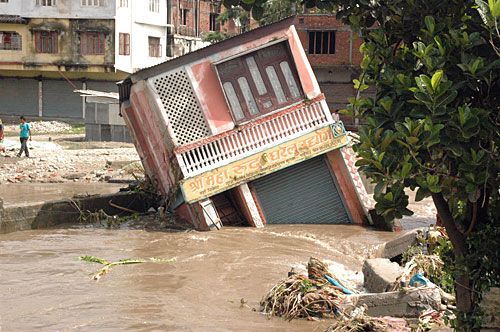 EARTH SHAKER: Flash floods from a swollen Aduwa river sweep away a store in Birtamod bazaar, Jhapa, on Friday. Eight people have already perished in Jhapa during floods brought on by this season's erratic monsoon.