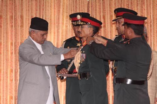 President Ram Baran Yadav decorates newly appointed Army Chief Chattraman Gurung with the insignia at the Presidential Palace, Shital Niwas on Wednesday