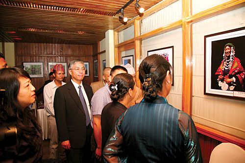 LHASA IN COLOUR: Chinese ambassador Quo Guohang observes a picture of a Tibetan woman on Wednesday at a photo exhibition entitled, 'Women in Tibet, China' organised by Sun City Art Gallery, Lhasa.