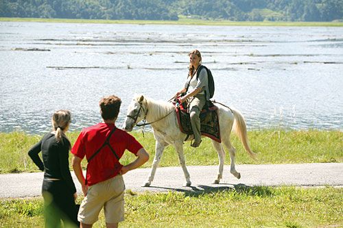 CLIP, CLOP: Tourists enjoy a pony trek by Pokhara's Phewa Lake on Friday. Clear mountain views this time of year draw many tourists to the popular city.