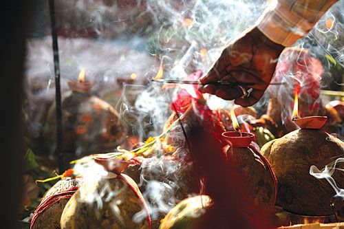 FOR PEACE: A devotee lights incense during Chhat, a religious festival practiced mainly by people in the Madhesh, in Birganj on Saturday.