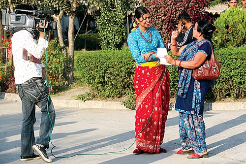 SMILE FOR THE CAMERA: Pawankali, host of a popular TV show, interviews CA members outside Singh Darbar on Tuesday.