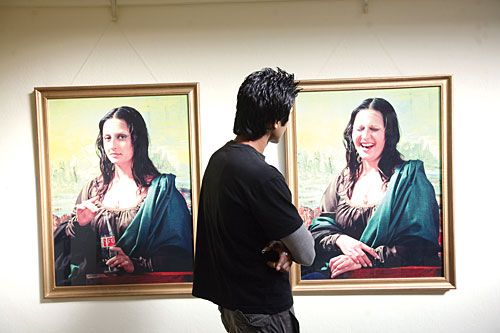 SPOT THE DIFFERENCE: An art enthusiast observes 'Mona Liza' by Pakistani artist Ambar Hammad during international art festival 'Separating Myth from Reality: Status of Women' on Wednesday.
