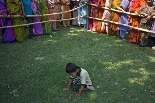 BORED KID: Five-year-old Subrat Chimire humours himself while waiting for his mother to cast her vote at Biratnagar-3 on April 10 2008. There are seperate queues for different gender voters.
