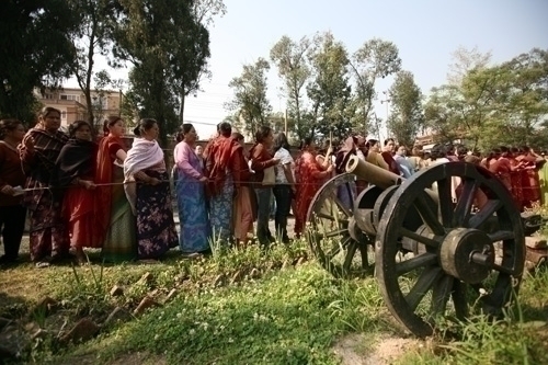 Women voters queue at a voting booth in Patan